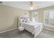 Cozy bedroom featuring a ceiling fan, plush carpet, and large windows with shutter style blinds at 1465 Laleiah Dr, Cumming, GA 30041