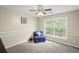 Cozy bedroom with a comfortable chair and large window providing natural light at 1465 Laleiah Dr, Cumming, GA 30041