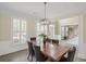 Formal dining room with a chandelier and a large table with black velvet chairs at 1465 Laleiah Dr, Cumming, GA 30041