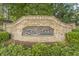 Stone entrance sign to Longlake community, nestled among lush greenery and mature trees at 1465 Laleiah Dr, Cumming, GA 30041