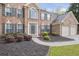 Elegant brick home with a two-car garage, manicured landscaping, and a welcoming front entrance at 1465 Laleiah Dr, Cumming, GA 30041