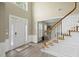 Inviting foyer with hardwood floors, staircase, and plenty of natural light at 1465 Laleiah Dr, Cumming, GA 30041