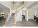 Elegant foyer with a staircase and views into the dining room at 1465 Laleiah Dr, Cumming, GA 30041