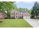 Charming two-story brick home featuring a well-manicured lawn and a two-car garage at 1465 Laleiah Dr, Cumming, GA 30041