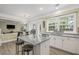 Eat-in kitchen with stainless appliances, island seating, and backyard view through the window at 1465 Laleiah Dr, Cumming, GA 30041