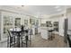 Bright kitchen with island, stainless steel appliances, and adjacent dining area at 1465 Laleiah Dr, Cumming, GA 30041