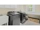 Efficient laundry room with modern machines, cabinets, sink, and a bright window for natural light at 1465 Laleiah Dr, Cumming, GA 30041