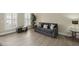 Comfortable living room with couch, foot rest, windows, light-colored walls, and stylish décor at 1465 Laleiah Dr, Cumming, GA 30041