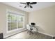 Bright office with large window, white chair, desk, ceiling fan, and natural light at 1465 Laleiah Dr, Cumming, GA 30041