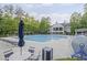 Relaxing pool area with plenty of seating, surrounded by lush landscaping and mature trees at 1465 Laleiah Dr, Cumming, GA 30041