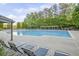 Spacious community pool with lap lanes, surrounded by lush greenery and lounge seating at 1465 Laleiah Dr, Cumming, GA 30041