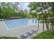Large community pool with lounge chairs, mature trees, and clear blue water at 1465 Laleiah Dr, Cumming, GA 30041