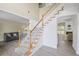 Inviting staircase with white rails leading to a living room and an adjacent Gathering room at 1465 Laleiah Dr, Cumming, GA 30041