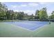 Well-maintained tennis courts with new nets and fencing, surrounded by lush greenery at 1465 Laleiah Dr, Cumming, GA 30041
