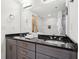 Bathroom featuring double sink vanity with granite countertop, modern fixtures, and tiled walk-in shower at 640 Glen Iris Ne Dr # 609, Atlanta, GA 30308