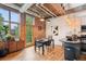 Dining area featuring exposed brick, modern lighting, and access to a small balcony at 640 Glen Iris Ne Dr # 609, Atlanta, GA 30308