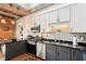 Close-up of modern kitchen featuring stainless steel appliances, two-tone cabinets, granite countertops, and hardwood floors at 640 Glen Iris Ne Dr # 609, Atlanta, GA 30308