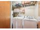 Laundry room features a side-by-side washer and dryer with storage shelves at 640 Glen Iris Ne Dr # 609, Atlanta, GA 30308