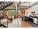 Spacious open-concept living room with exposed brick, hardwood floors, and modern kitchen at 640 Glen Iris Ne Dr # 609, Atlanta, GA 30308