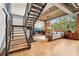Open-concept living room with hardwood floors, large windows, and metal staircase at 640 Glen Iris Ne Dr # 609, Atlanta, GA 30308