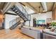 Open-concept living room with hardwood floors, modern decor, and a staircase to the upper level at 640 Glen Iris Ne Dr # 609, Atlanta, GA 30308