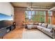 Bright living room features large windows, exposed brick, and comfortable sectional sofa at 640 Glen Iris Ne Dr # 609, Atlanta, GA 30308