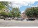 View of Glen Iris Lofts building with parked cars on a tree-lined street at 640 Glen Iris Ne Dr # 609, Atlanta, GA 30308