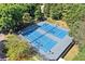 Aerial view of tennis courts surrounded by lush green trees at 6510 Newcastle Way, Cumming, GA 30040