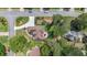 Aerial view of house with circular driveway, mature trees, and a red umbrella-shaded patio at 6510 Newcastle Way, Cumming, GA 30040