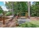 Relaxing backyard featuring a wooden swing, hammock, landscaping and privacy fence at 6510 Newcastle Way, Cumming, GA 30040