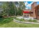 Landscaped backyard featuring a covered patio with an outdoor dining area and beautiful plants at 6510 Newcastle Way, Cumming, GA 30040