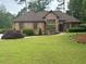 Charming home with beautiful landscaping, a well-manicured lawn, and a stone exterior at 6510 Newcastle Way, Cumming, GA 30040