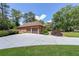 Beautiful shot of the garage featuring a long driveway and established landscaping at 6510 Newcastle Way, Cumming, GA 30040