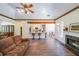 Open-concept living room featuring hardwood floors, fireplace and bar seating at the kitchen counter at 6510 Newcastle Way, Cumming, GA 30040