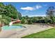 Outdoor pool and spa with water slide surrounded by lush landscaping at 6510 Newcastle Way, Cumming, GA 30040