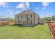 Large backyard featuring a covered patio and newly installed sod at 6944 Melody Ridge Rd, Buford, GA 30518