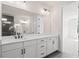 Bright bathroom with white vanity, dual sinks, modern fixtures, and a view of the walk-in shower at 6944 Melody Ridge Rd, Buford, GA 30518