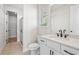 Bathroom featuring a white vanity with black hardware and tile floors at 6944 Melody Ridge Rd, Buford, GA 30518