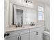 Bathroom featuring double sinks, granite countertops, and modern fixtures at 6944 Melody Ridge Rd, Buford, GA 30518