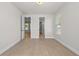 Bedroom featuring neutral walls, wood floors, and open doorways at 6944 Melody Ridge Rd, Buford, GA 30518