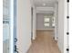 Bright entryway features light hardwood floors, gray walls, white trim, and an open floor plan at 6944 Melody Ridge Rd, Buford, GA 30518