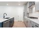 Modern kitchen with an island sink, stainless steel appliances, and stylish finishes at 6944 Melody Ridge Rd, Buford, GA 30518
