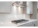 Modern kitchen featuring a gas range, white countertops, light gray cabinets, and mosaic backsplash at 6944 Melody Ridge Rd, Buford, GA 30518