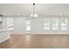 Bright, open living area featuring hardwood floors, a door to the yard, and neutral finishes at 6944 Melody Ridge Rd, Buford, GA 30518