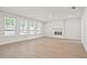 Open-concept living area featuring hardwood flooring and a fireplace at 6944 Melody Ridge Rd, Buford, GA 30518