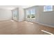 Sun-lit living room featuring light wood flooring and large windows with views at 6944 Melody Ridge Rd, Buford, GA 30518