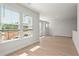 Spacious living room with light wood flooring, lots of natural light and large windows at 6944 Melody Ridge Rd, Buford, GA 30518