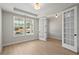 Stylish office with French doors, bright windows, and light hardwood floors offers a productive workspace at 6944 Melody Ridge Rd, Buford, GA 30518