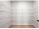 Spacious walk-in pantry with white wire shelving and hardwood flooring at 6944 Melody Ridge Rd, Buford, GA 30518