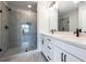 Elegant bathroom featuring a glass-enclosed shower and double vanity with modern fixtures, blending style and functionality at 4810 Floydwood Ln, Mableton, GA 30126